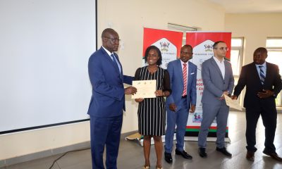 Mr. Ashaba Hannington (L), who represented the Permanent Secretary of MoFPED presents a certificate to one of the participants as the Principal CoBAMS, Prof. Eria Hisali (C), Dean of the School of Economics, Prof. Ibrahim Okumu (R) and another official witness on 10th February 2023.