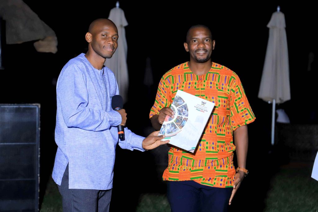 Dr. David Musoke (Left) handing over the grant award to Dr. John Ssenkusu (Right).