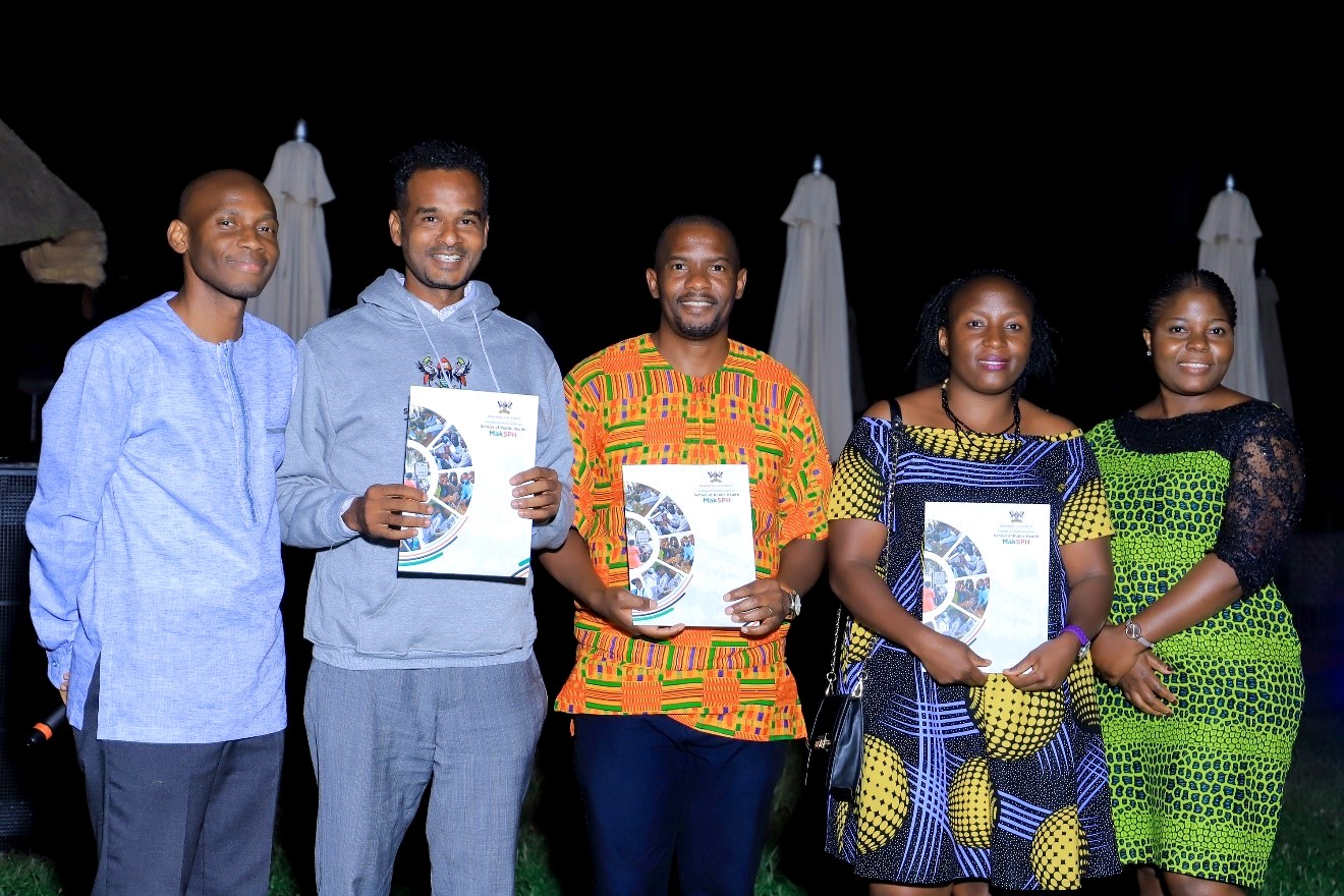 Dr. David Musoke – Chair of the Grants and Research Capacity Building Committee (Left) and Ms. Stella Kakeeto – Secretary of the Grants and Research Capacity Building Committee (Right) with the three grant recipients (Left to Right: Mr. Abdullah Ali Halage, Dr. John Ssenkusu, and Ms. Juliana Namutundu) after the award ceremony on 16th December 2022.