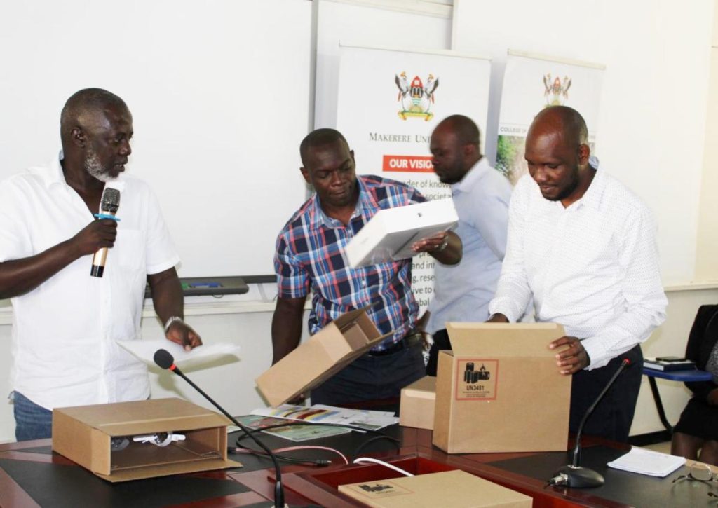 Dr. Edgar Nabutanyi and the IT team unpacking some of the laptops.