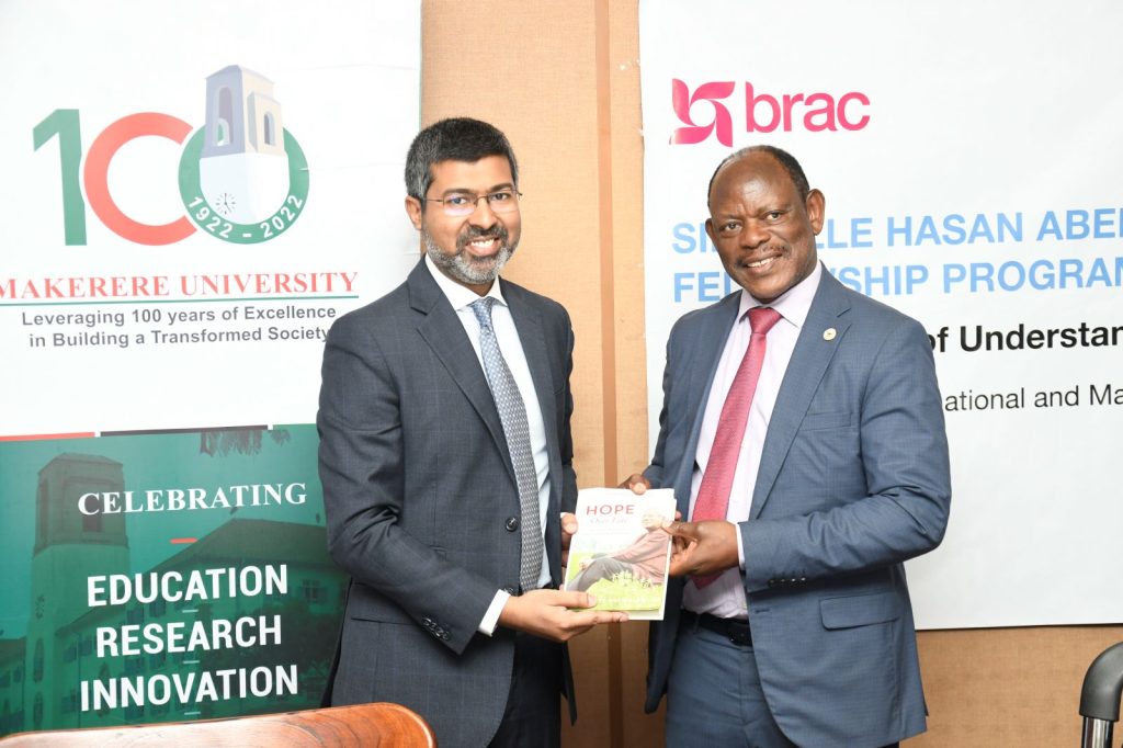 Prof. Barnabas Nawangwe (R) receives a souvenir from Mr. Shameran Abed (L) after the MoU signing. 