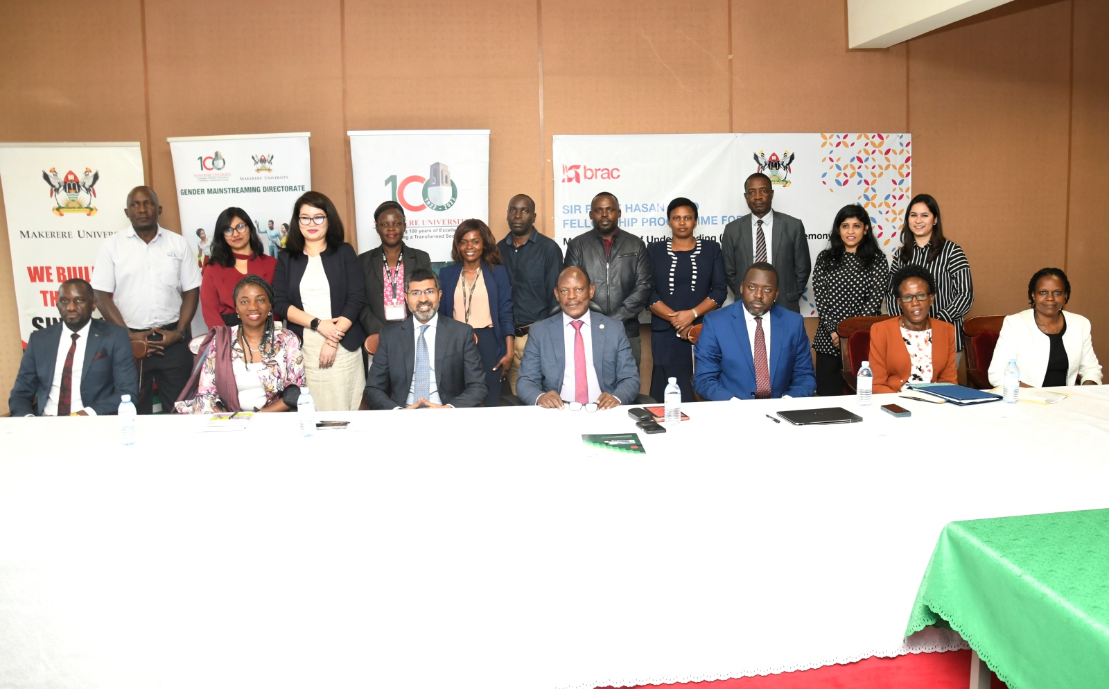 Seated: The Vice Chancellor-Prof. Barnabas Nawangwe (C), ED BRAC International-Mr. Shameran Abed (3rd L) and University Secretary-Mr. Yusuf Kiranda (3rd R) with R-L: BRAC Uganda Country Director-Ms. Spera Atuhairwe, Ag. Director GMD-Ms. Susan Mbabazi, BRAC Regional Director Africa-Ms. Rudo Kayombo and Deputy University Secretary-Mr. Simon Kizito with other officials (Standing) after the MoU Signing on 29th March 2023, Council Room, Makerere University.