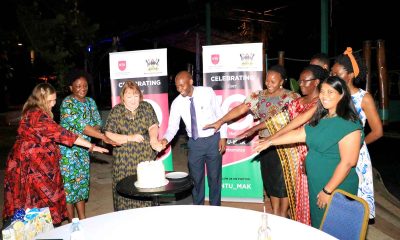 The NTU-Mak partnership leads Prof. Linda Gibson (3rd L) and Dr. David Musoke (4th L) are joined by the Dean MakSPH, Prof. Rhoda Wanyenze (2nd L) and other officials to cut cake during the celebration of 10 years of collaboration in December 2022.