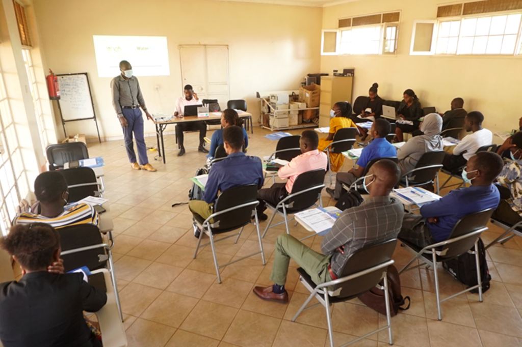 Mr. Douglas Bulafu (standing) talking to the research assistants during the training before data collection.