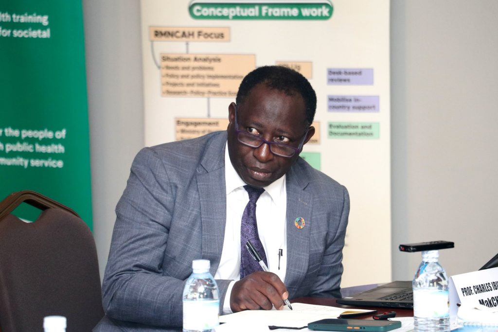Prof. Charles Ibingira, the team lead on the project takes notes during the RMNCAH partner's engagement.