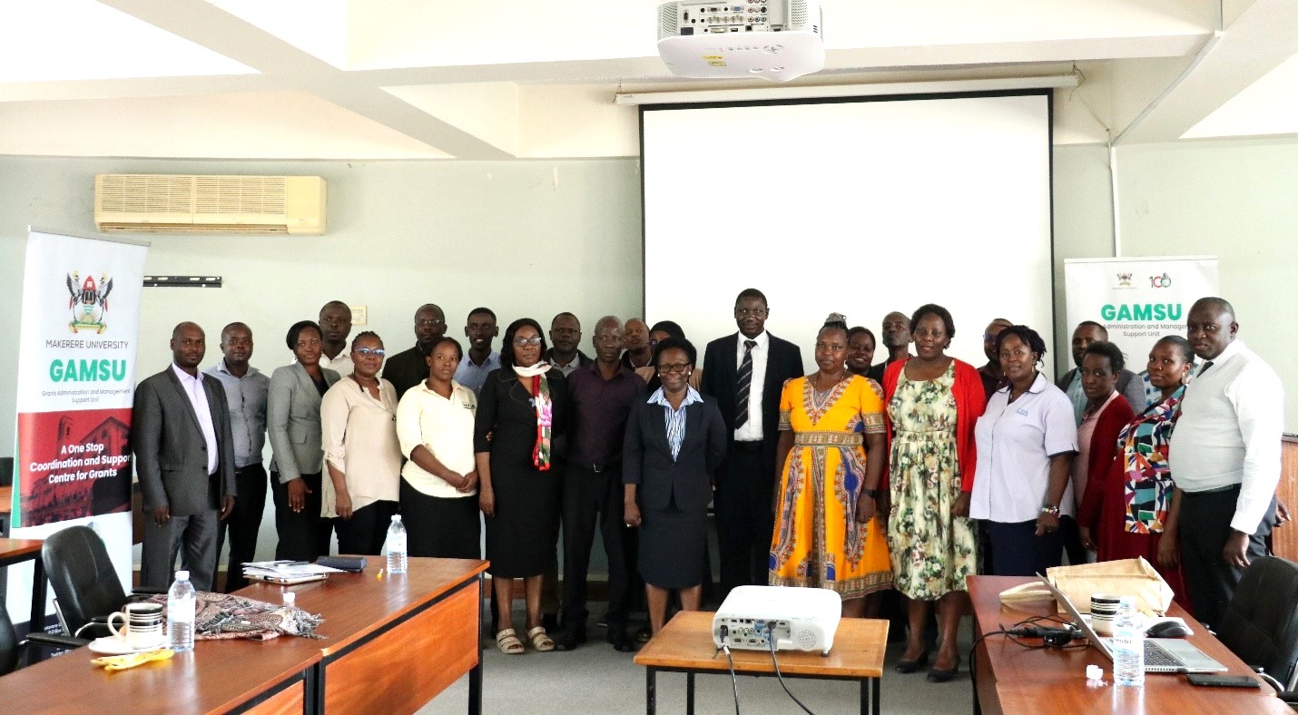 Prof. Sylvia Nannyonga-Tamusuza and Dr. Cyprian Misinde (Centre) with participants at the hands-on workshop on navigating funder platforms and the GAMSU database management system, 16th March 2023, Telepresence Centre, Senate Building, Makerere University.