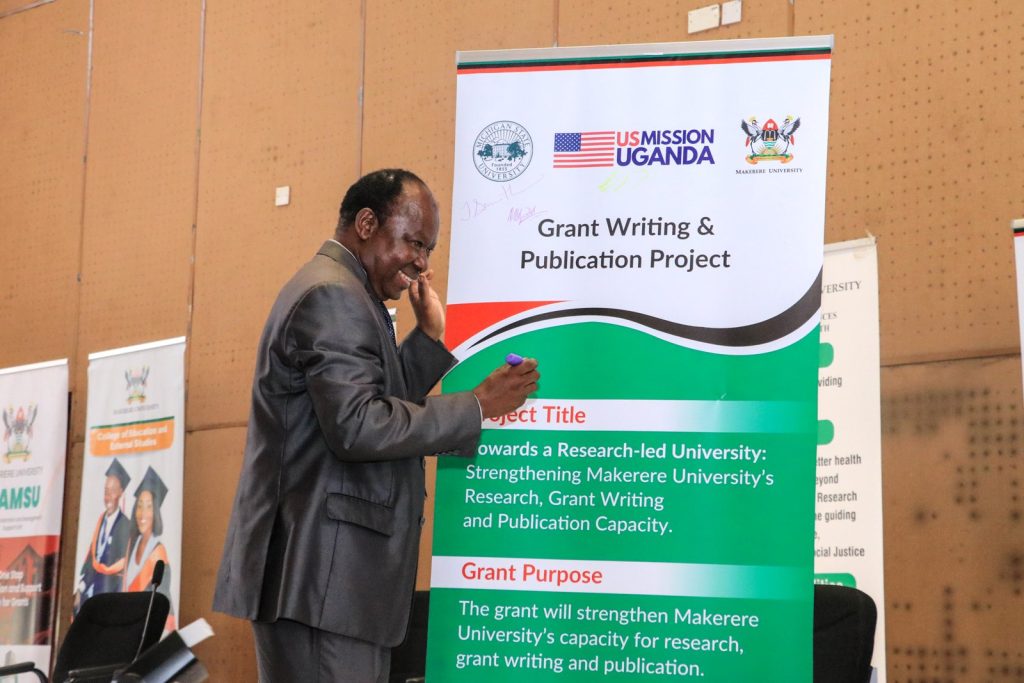 Professor Fredrick J. Muyodi, the team lead from the Makerere University’s Department of Zoology, Entomology and Fisheries Sciences signs the banner at the launch.