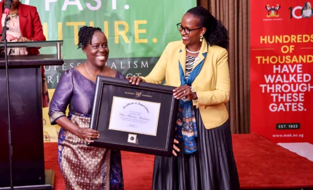 Lady Justice Prof. Lillian Tibatemwa-Ekirikubinza (Left) receives her Certificate of Recognition from Mrs. Lorna Magara (Right).