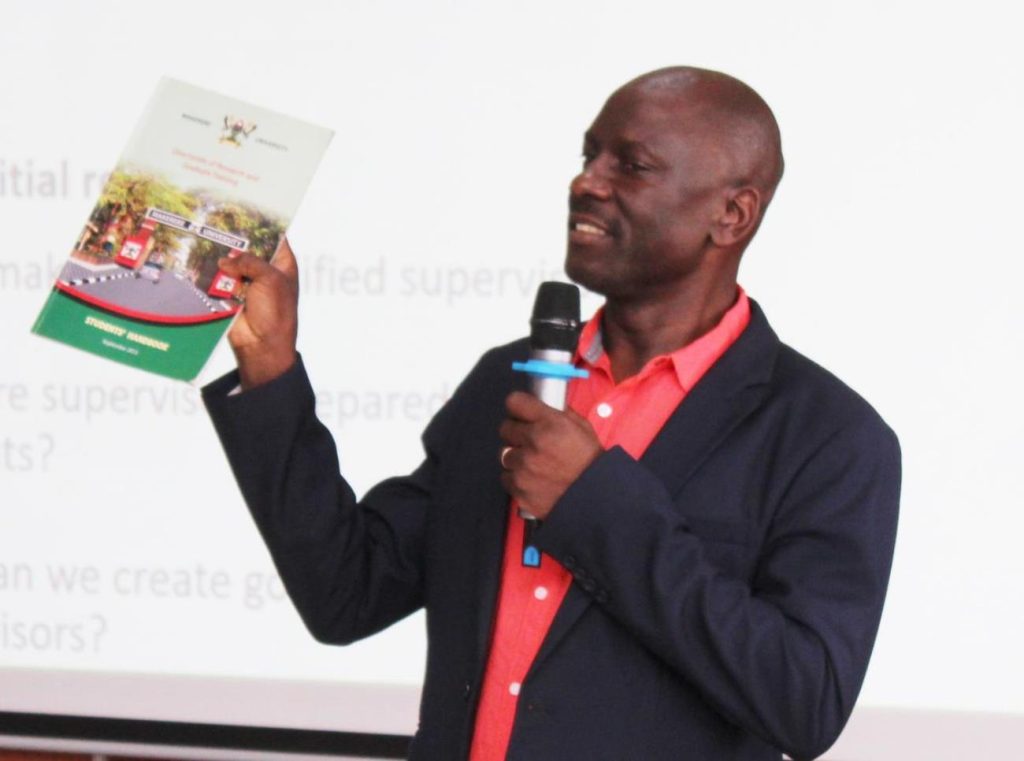 Assoc. Prof. Julius Kikooma emphasising the need to understand the Graduate Handbook 2013.