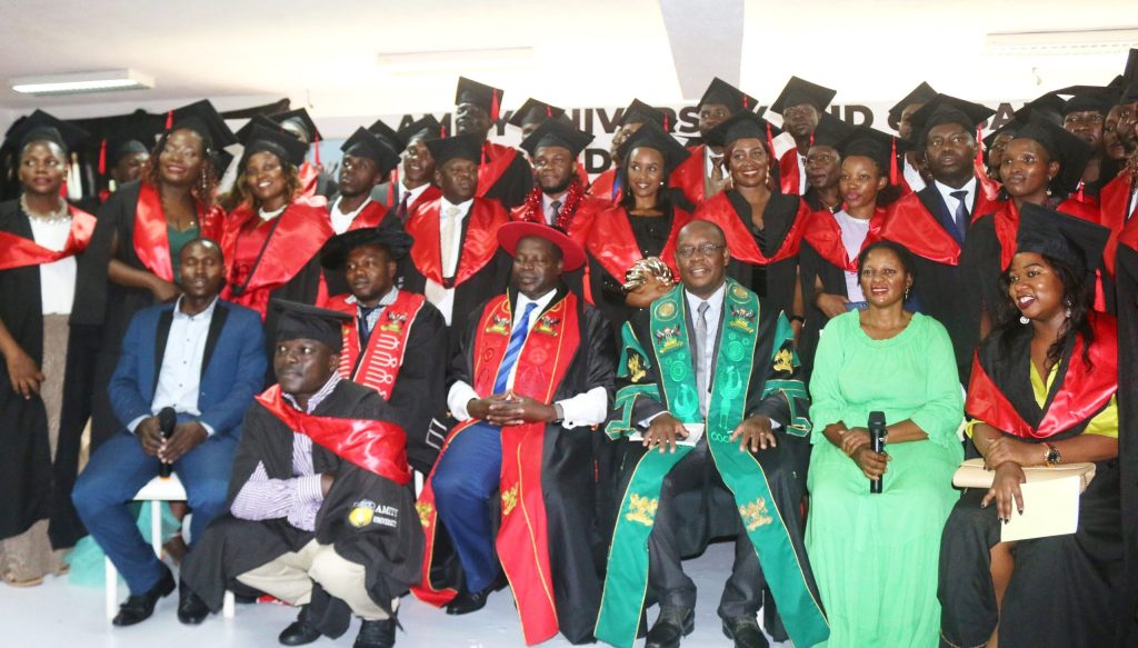 Another section of graduands posing for a group photo with the college management.