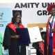 The Principal CoCIS, Prof. Tonny Oyana (Right) joined by the Head CIPSD-Ms. Barbara Nalubega (Left) presents a certificate to one of the over 300 graduands who pursued education under the auspices of the Makerere-Amity and e-VBAB Project during the award ceremony held on 14th April 2023 at CoCIS, Makerere University.