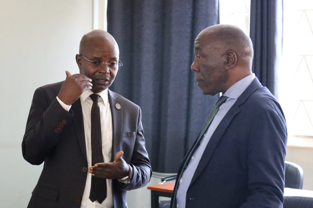 Prof. Edward Bbaale (Left) and Eng. Prof. Henry Alinaitwe (Right) interact after the graduation ceremony and program launch.
