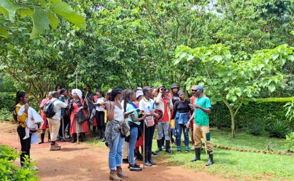 Students receiving a lecture on environmental conservation by the tour guide.