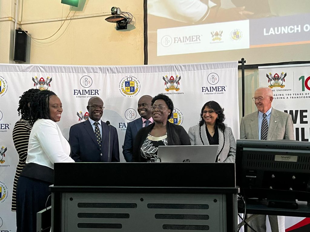 Prof. Damalie Nakanjako (L) presents the EAFRI Director-Prof. Sarah Kiguli a the launch, Davies Lecture Theatre, CHS, Makerere University, Mulago Hill, Kampala Uganda.