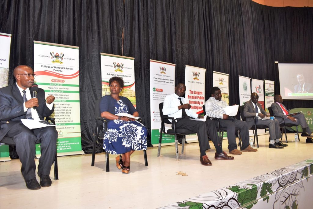 The panelists - Prof. Tugume; Dr. Barbara Mugwanya Zawedde, Director of Research at NARO; Mr. Peter Watiti, a primary school teacher; Dr. Andrew Kiggundu, a geneticist and biotechnologist; Mr. Nixon Opoya, a secondary school teacher and examiner at UCE and UACE; and Dr Godwin Anywar from the Department of Plant Sciences, Microbiology and Biotechnology, CoNAS, Yusuf Lule Auditorium, Makerere University, Kampala Uganda.