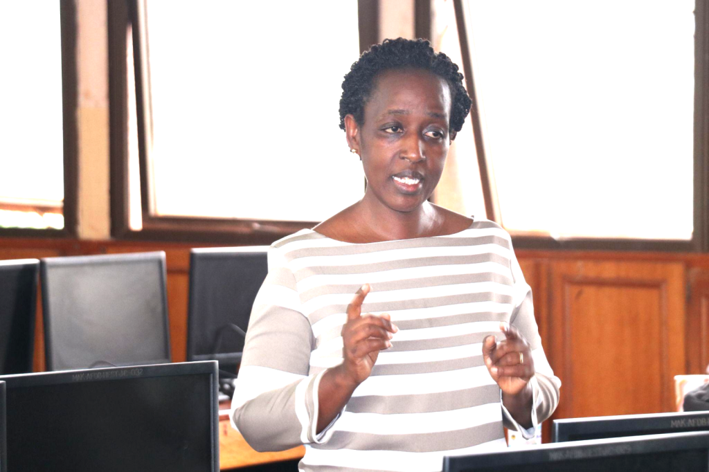 Ms. Christine Ninsiima facilitating a session on Budgeting and Financial Management procedures and guidelines for staff at the Sensitization Workshop.