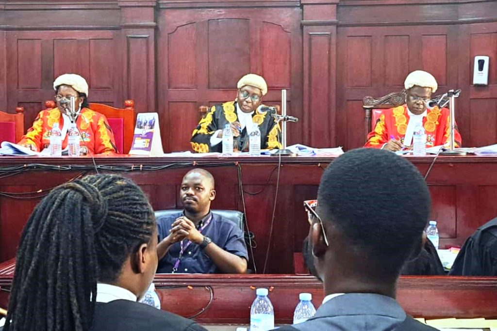 The Judges presiding over the 9th CLE Moot Court Competition L-R: Justice Florence Nakachwa Dollo, Justice Geoffrey Kiryabwire, and Justice Dr. Douglas Singiza.
