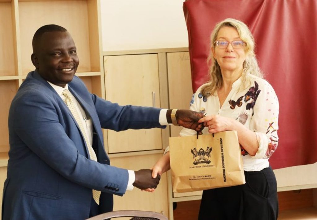 Prof. Obura handing over a gift to Sirpa Bark. EASLIS, CoCIS, Makerere University, Kampala Uganda.