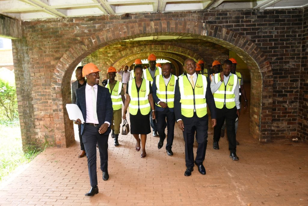 Eng. Darius Muwanguzi (L) leads the Prof. Barnabas Nawangwe (2nd R), Mrs. Winifred Kabumbuli (2nd L), Eng. Brian Buhanda (R) and other officials on a tour of Block C of Lumumba Hall. Makerere University, Kampala Uganda.