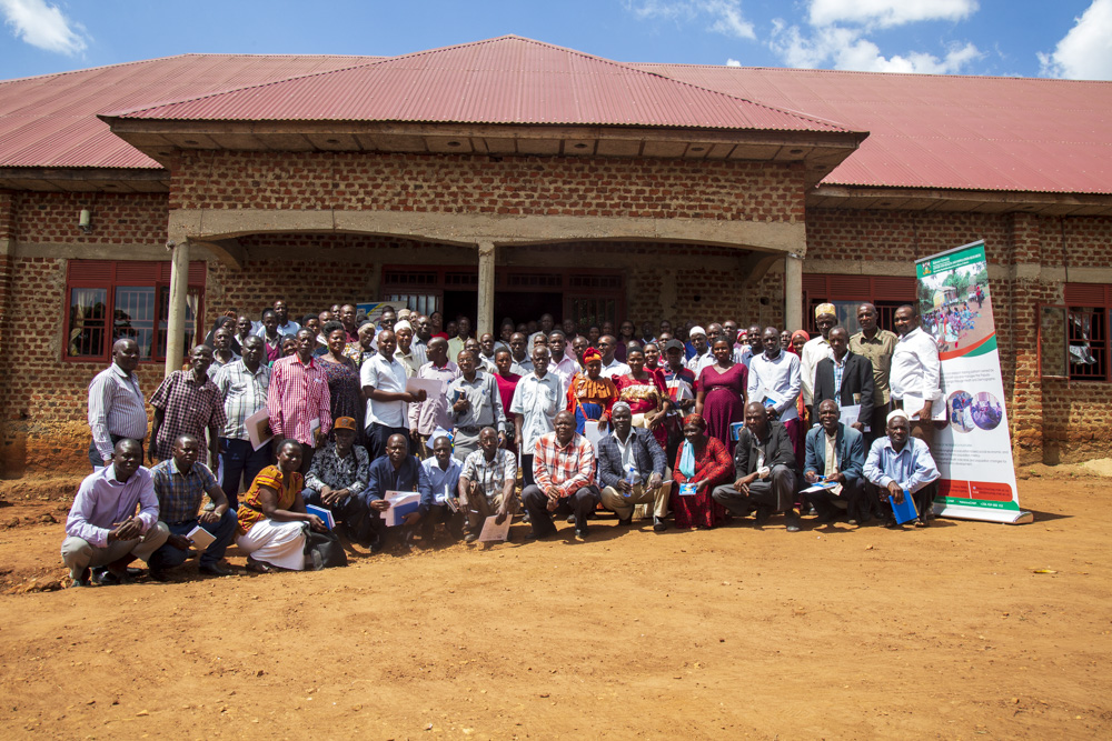 Dr. Kajungu Dan (extreme left) and NIRA officials pose for a group photo with VHT's, LC1 Chairpersons and scouts after training on death registration at MUCHAP offices in Iganga District on 29th May 2023.