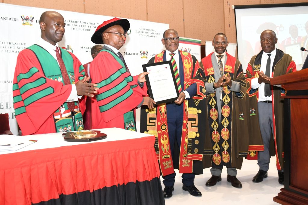 Prof. Barnabas Nawangwe (Centre) presents Prof. John H. Muyonga with a certificate follow the delivery of his Professorial Inaugural Lecture as Prof. Umar Kakumba (2nd R), Prof. Henry Alinaitwe (R) and Prof. Yazidhi Bamutaze (L) applaud. Yusuf Lule Central Teaching Facility Auditorium, Makerere University, Kampala Uganda.