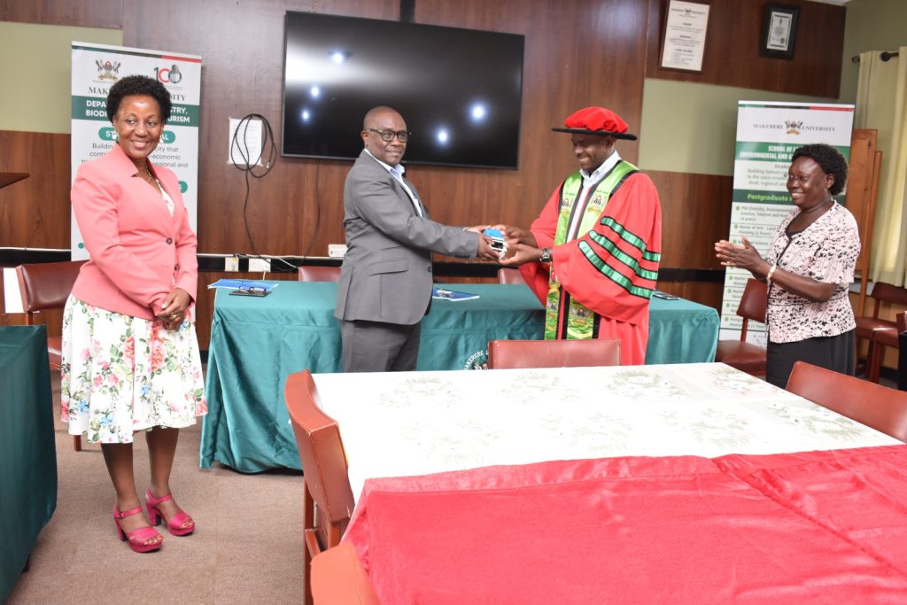 Dr. Babweteera hands over some of the office instruments to Dr. Twinomuhangi. School of Forestry, Environmental and Geographical Sciences (SFEGS), College of Agricultural and Environmental Sciences (CAES), Makerere University, Kampala Uganda. East Africa.