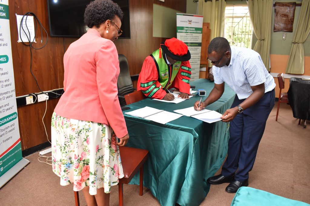 Dr. Babweteera and Dr. Twinomuhangi sign the handover report as Prof. Nabanoga (L) witnesses. Dr. Babweteera and Dr. Twinomuhangi sign the handover report as Prof. Nabanoga (L) witnesses.