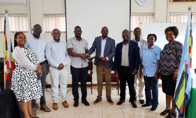 Mr. David Ikomo (4th Left) and Mr. Stephen Byarugaba (5th Left) shake hands as other officials witness during the handover ceremony held on 7th July 2023. The Conference Room, Level 4, Block A, College of Computing and Information Sciences (CoCIS), Makerere University, Kampala Uganda, East Africa.