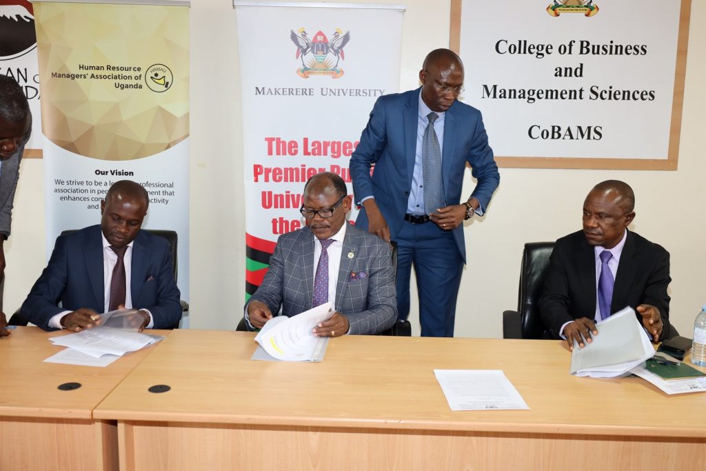 Prof. Barnabas Nawangwe (Centre), Mr. Ronald Bbosa (Left) as Prof. Eria Hisali (Right) sign the MoU. Conference Room, Block B, Level 2, School of Business, Makerere University, Kampala Uganda.