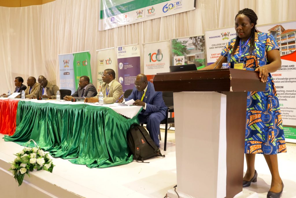 Assoc. Prof. Ruth Nalumaga (Right) shares reflections from the University Library on the day's theme. Other panelists (Seated) contributed reflections from their respective institutions. Yusuf Lule Central Teaching Facility Auditorium, Makerere University. Kampala Uganda. East Africa.