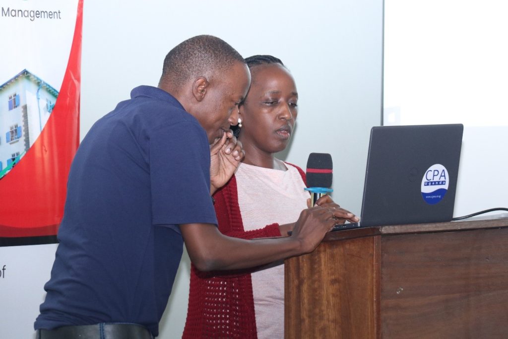 Mr. Denis Wamala, GAMSU ICT support and CPA Christine Ninsiima navigating the GAMSU database in preparation for Christine's session. Telepresence Centre, Senate Building, Makerere University, Kampala Uganda.