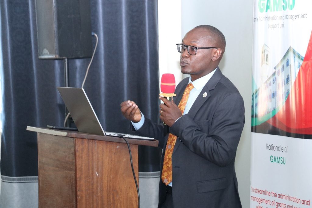 Mr. George Turyamureeba the head finance, discussing on how to prepare and submit quarterly reports. Telepresence Centre, Senate Building, Makerere University, Kampala Uganda.