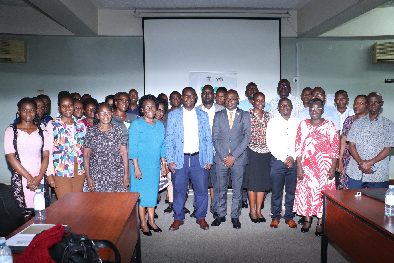 Prof. Sylvia Nannyonga-Tamusuza, (in blue) Mr. Evarist Bainomugisha (5th left), and Mr. George Turyamureeba (Centre) posing for a photo moment with accountants and Project administrators that attended the workshop on the University Policies and procedures for grants at Makerere University on 29th June 2023, Telepresence Centre, Senate Building. Kampala Uganda.