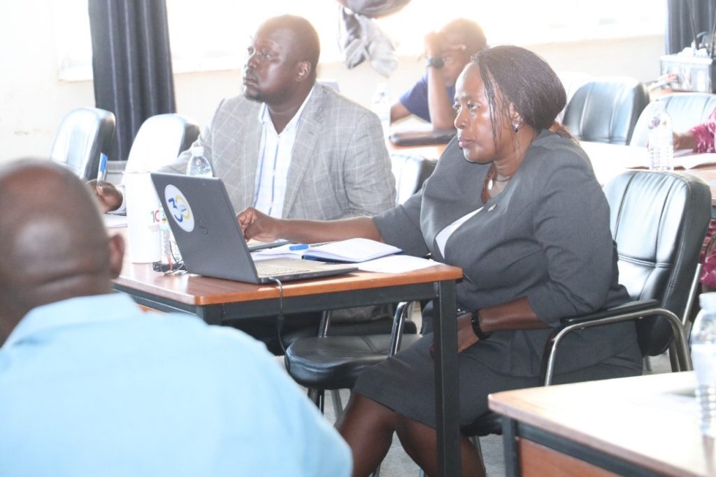 Some of the accountants; Mr. Walter Odoch (Left) and Ms. Suzan Kyamulabi (Right) follow proceedings during the training. Telepresence Centre, Senate Building, Makerere University, Kampala Uganda.
