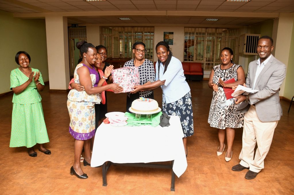 Staff led by the University Librarian, Assoc. Prof. Ruth Nalumaga (3rd Right) present a gift to Assoc. Prof. Helen Byamugisha in appreciation of her leadership. University Library Boardroom, Makerere University, Kampala Uganda.