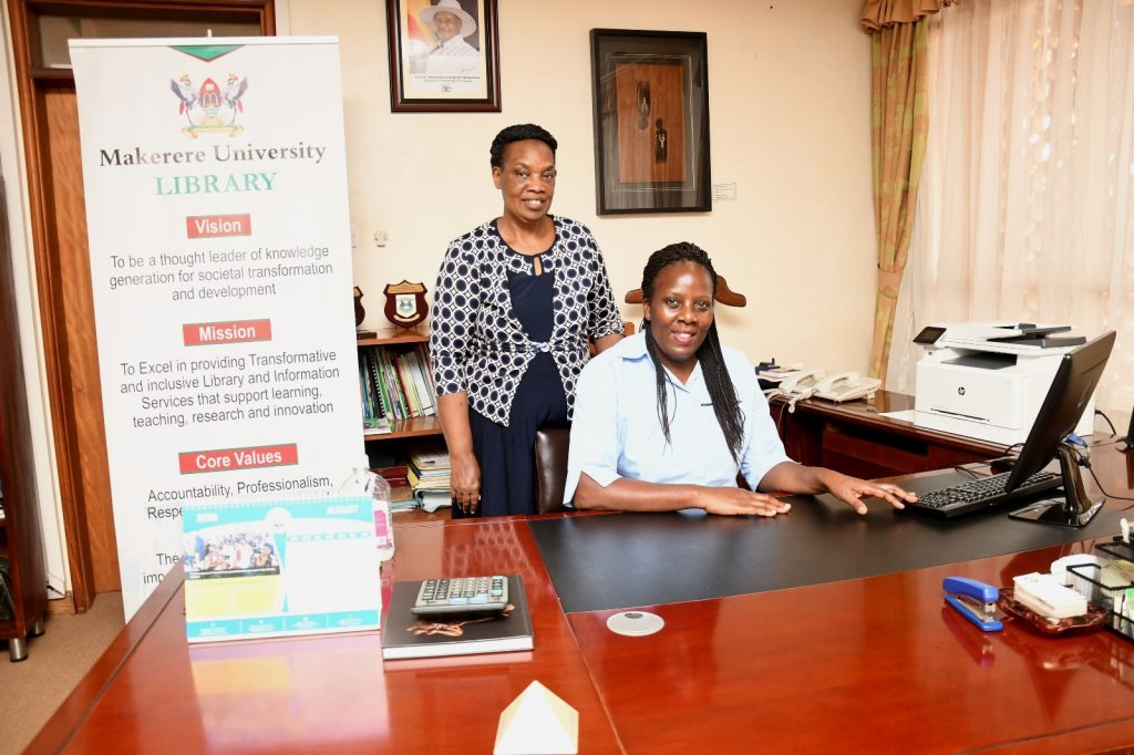 Assoc. Prof. Ruth Nalumaga (Seated) with Assoc. Prof. Helen Byamugisha (Standing) in the University Librarian's Office shortly after the handover ceremony. University Library Boardroom, Makerere University, Kampala Uganda.