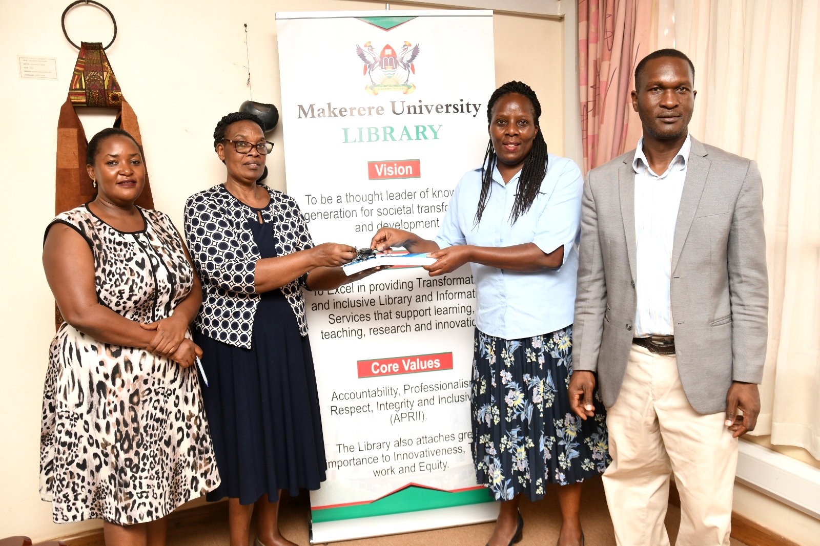 Assoc. Prof. Ruth Nalumaga (2nd Right) receives the handover report from outgoing University Librarian Assoc. Prof. Helen Byamugisha (2nd Left). Ms. Ikiriza Racheal (Left) represented the Directorate of Human Resources while Mr. Aggrey Luwuliza (Right) represented the Directorate of Internal Audit at the handover ceremony held in the University Library Boardroom on 7th July 2023. Makerere University, Kampala Uganda, East Africa.