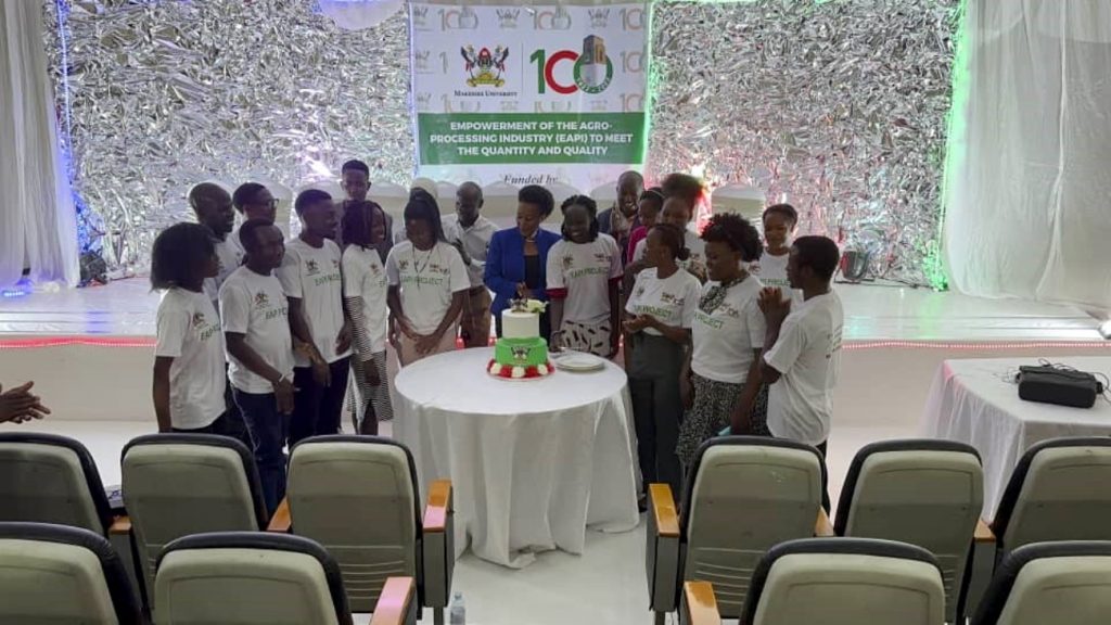 Trainees cut cake to celebrate their achievement. The Conference Hall, School of Food Technology, Nutrition and Bioengineering, CAES, Makerere University, Kampala Uganda, East Africa.