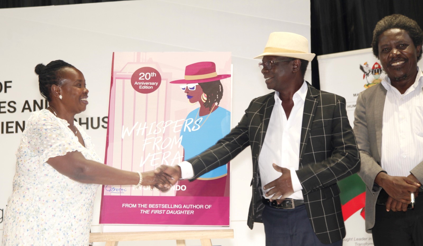 Goretti Kyomuhendo (Left) shakes hands with the Chief Guest and Head of Afrigo Band, Mr. Moses Matovu (Centre) as Prof. Patrick Mangeni witnesses at the re-launch of "Whispers from Vera" on 26th August 2023, Yusuf Lule Auditorium, Makerere University. Kampala Uganda, East Africa.