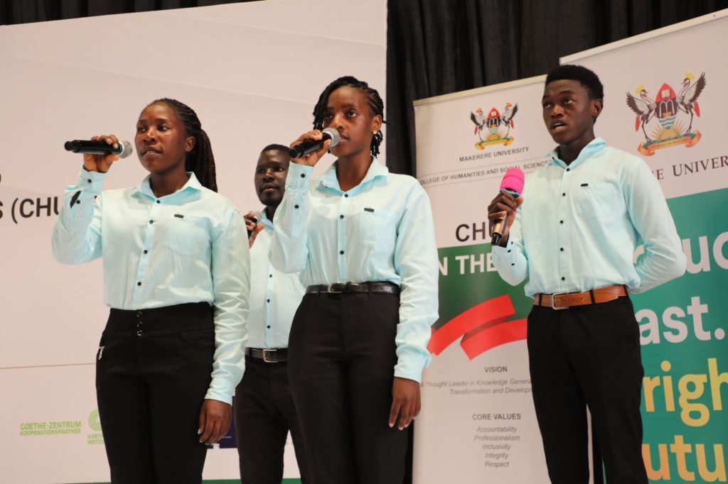 Students of Performing Arts and Film lead participants through the anthems. Yusuf Lule Auditorium, Makerere University, Kampala Uganda. East Africa.