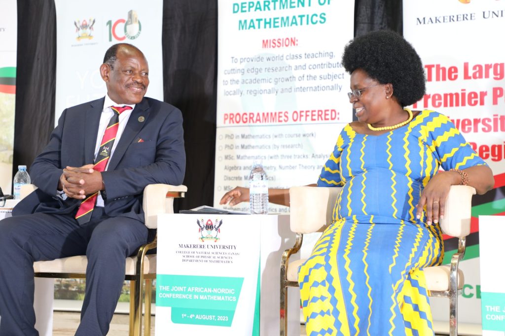 Prof. Barnabas Nawangwe (Left) and Hon. Dr. Monica Musenero (Right) share a light moment during the Conference. Yusuf Lule Central Teaching Facility, Makerere University, Kampala Uganda, East Africa. 