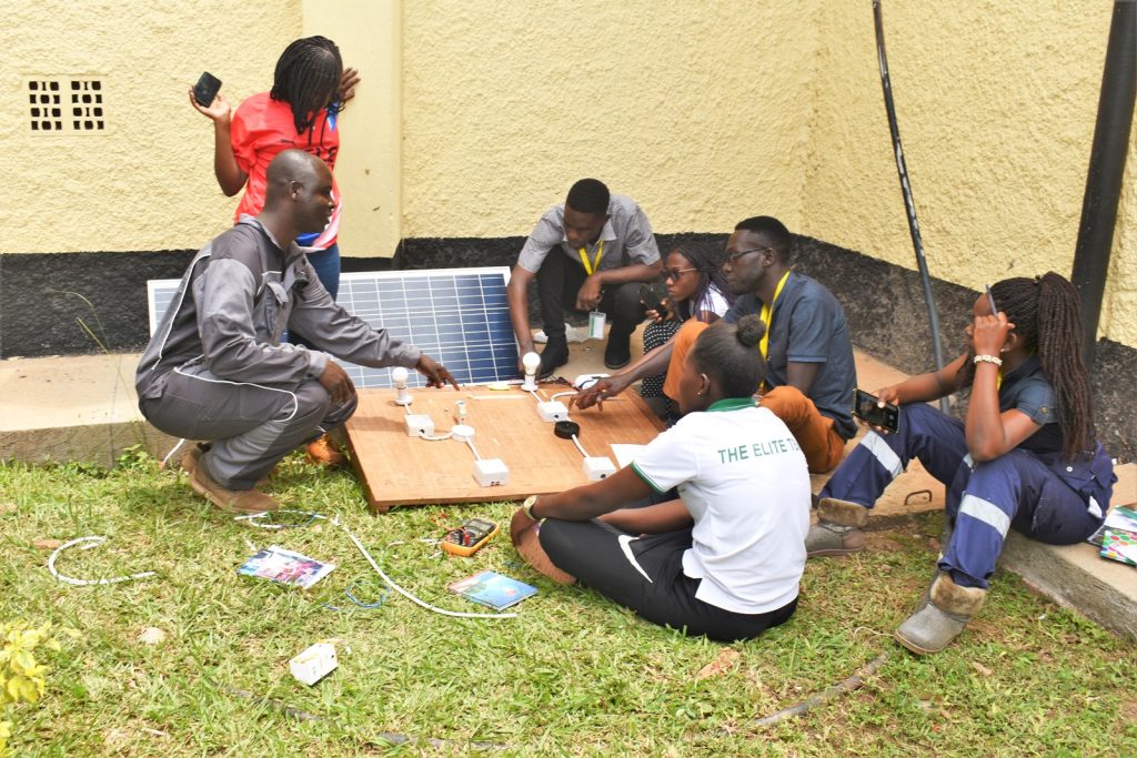 Mr. Jimmy Chaciga (Left), a PhD student funded by the EnergyNET Project guides the students. Department of Physics, Makerere University, Kampala Uganda, East Africa.