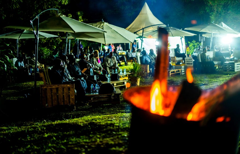 The audience follows proceedings of the Ekyooto. JNLC Gardens, Makerere University. Kampala Uganda East Africa.