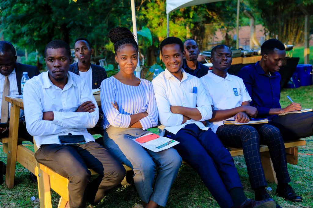 Some members of the audience at the Ekyooto smile for the camera. JNLC Gardens, Makerere University. Kampala Uganda East Africa.