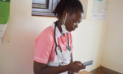 A nurse scrolls through her smartphone. Photo: DHPI-R, MakSPH, CHS, Makerere University, Kampala Uganda, East Africa.