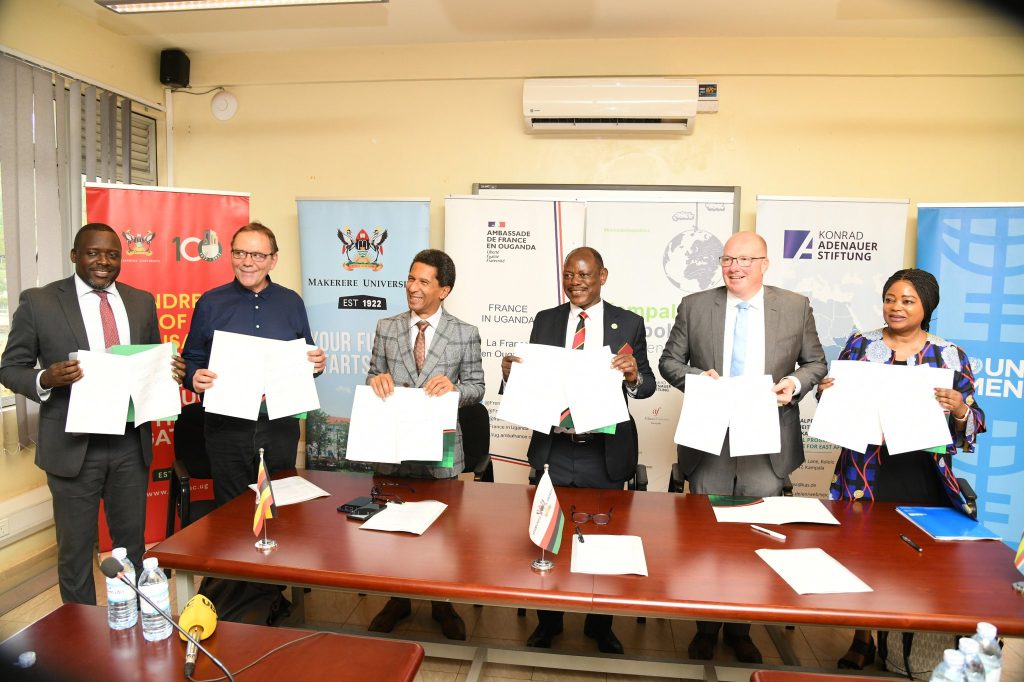 The Partners are joined by the University Secretary, Mr. Yusuf Kiranda (Left) to show off the signed MoU. Rotary Peace Centre Boardroom, Level 3, Yusuf Lule Central Teaching Facility, Makerere University, Kampala Uganda, East Africa.