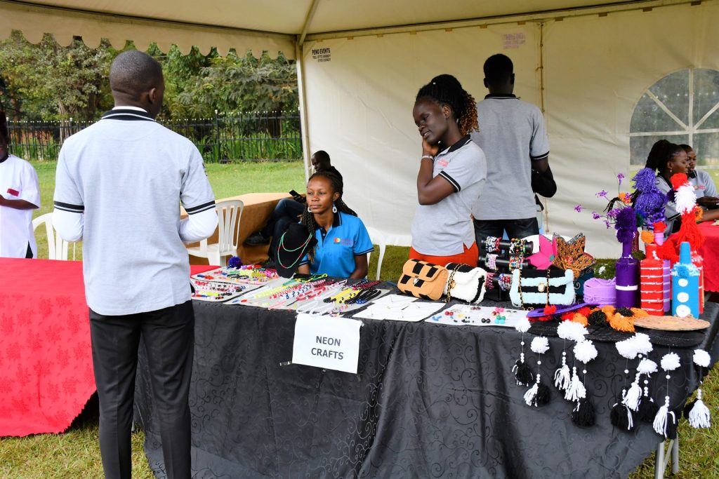 A member of the Alumni interacts with some of the exhibitors during the event. Mastercard Foundation Scholars Program Annual Community Open Day, 2nd September 2023, Freedom Square, Makerere University, Kampala Uganda, East Africa.