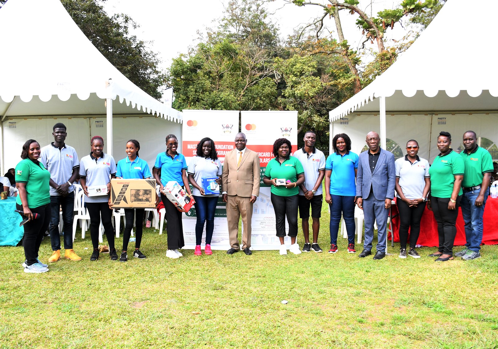 Hon. John Bosco Ngoya (7th Left), Prof. Henry Alinaitwe (4th Right), Prof. Justine Namaalwa (Left) with raffle draw winners and officials at the Open Day on 2nd September 2023. Mastercard Foundation Scholars Program Annual Community Open Day, Freedom Square, Makerere University, Kampala Uganda, East Africa.