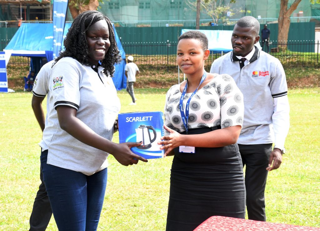 One of the raffle draw winners receives her prize. Mastercard Foundation Scholars Program Annual Community Open Day, 2nd September 2023, Freedom Square, Makerere University, Kampala Uganda, East Africa.