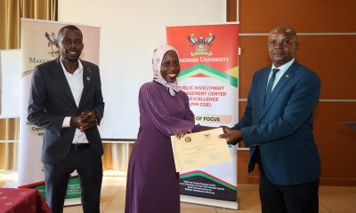 The Director of Research and Graduate Training and Principal Investigator of the PIM Centre of Excellence, Prof. Edward Bbaale (Right) presents a certificate to Ms. Saidat Bawomya from the National Planning Authority (Centre) as another official witnesses.